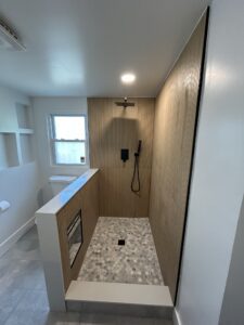 New tiled shower installation with modern fixtures during bathroom renovation in Cincinnati