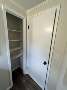 Small powder room renovation featuring modern lighting, compact layout, and luxury vinyl flooring (linen closet)