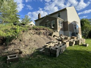 Collapsed retaining wall with severe erosion and hillside slope failure in Mt. Airy Cincinnati Ohio