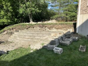 Severely deteriorated retaining wall showing structural collapse and unstable hillside in Cincinnati Ohio
