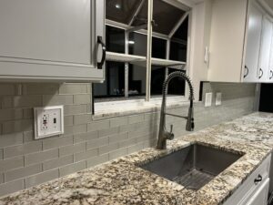 Modern subway tile backsplash installation with granite countertops in Forest Park Cincinnati Ohio